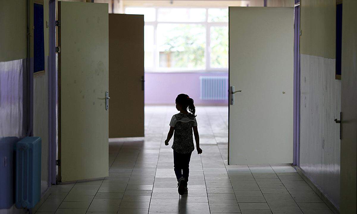 A Syrian refugee student walks along a corridor at Fatih Sultan Mehmet School in Karapurcek district of Ankara