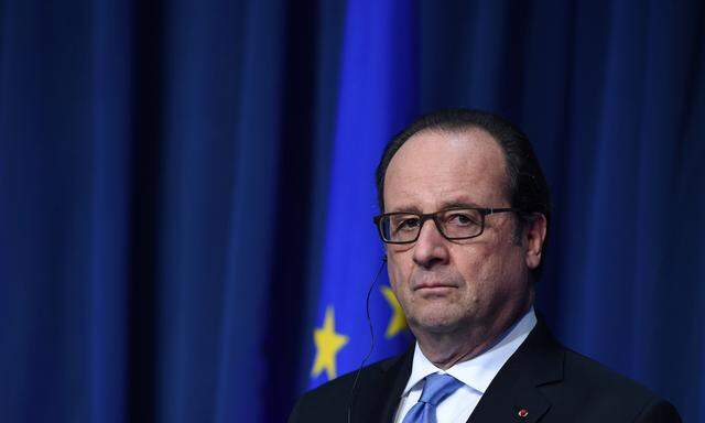 French President Francois Hollande looks on at a press conference at Government Buildings in Dublin