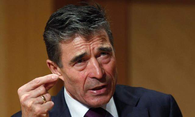 NATO Secretary General Fogh Rasmussen gestures while speaking after receiving the Hillary Rodham Clinton Award for Advancing Women in Peace and Security at Georgetown University in Washington