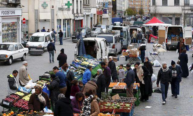 People shop at a market in the neighbourhood of Molenbeek in Brussels, Belgium