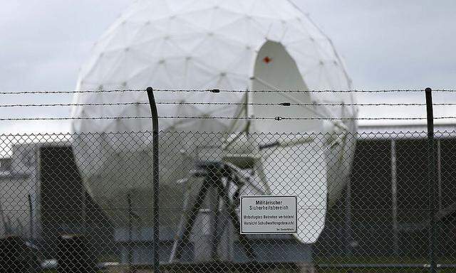 A sign hangs from a fence in front of the former monitoring base of the U.S. National Security Agency in Bad Aibling