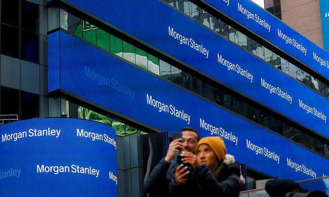 FILE PHOTO: People take photos by the Morgan Stanley building in Times Square in New York