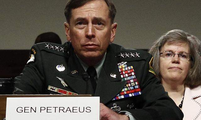 File photo of General Petraeus and his wife at a hearing in Washington