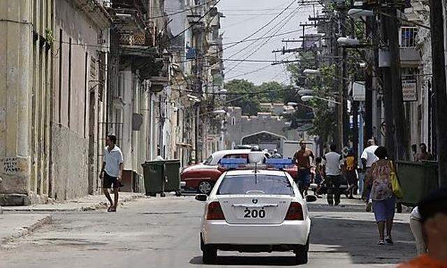 A Cuban police Geely CK Chinese-made patrol car patrols a street in Havana