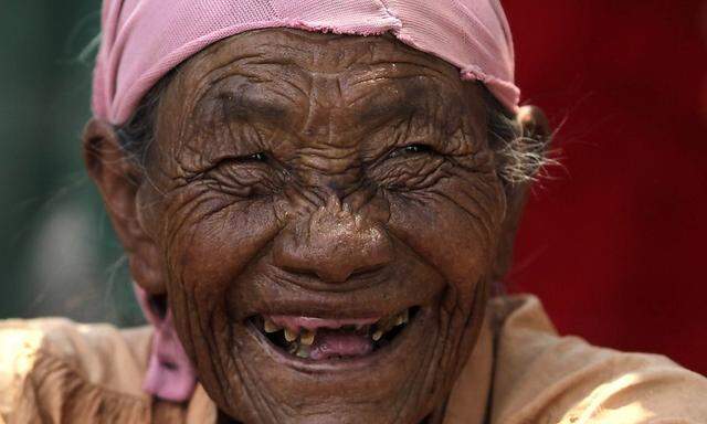 Kemha Yatsepo tribe member laughs as workers from UN's World Food Programme deliver food supplies to them in Chaco Paraguayo