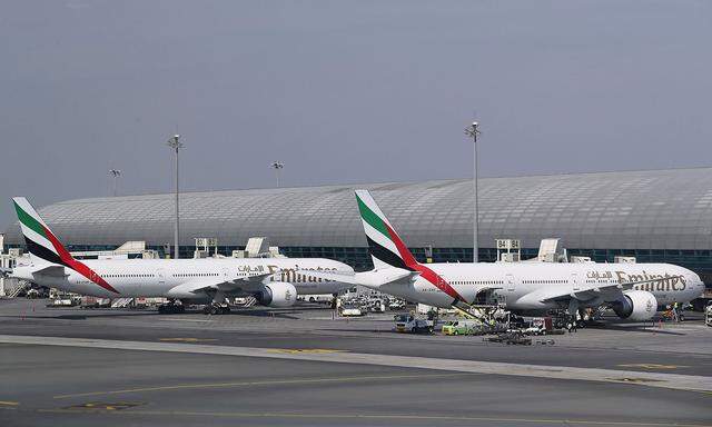 FILE PHOTO: Emirates Airlines Boeing 777-300ER airliners are seen parked at Terminal 3 of Dubai International Airport