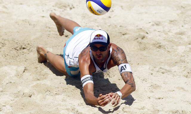 Austria´s Doppler dives for the ball during their FIVB Beachvolleyball Grand Slam match against Bellaguarda and Heuscher from Switzerland in Klagenfurt