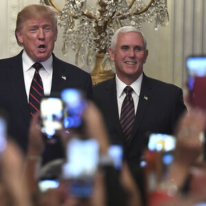 President Donald Trump (L) and Vice President Mike Pence are greeted by guests and their mobile phones as they arrive fo