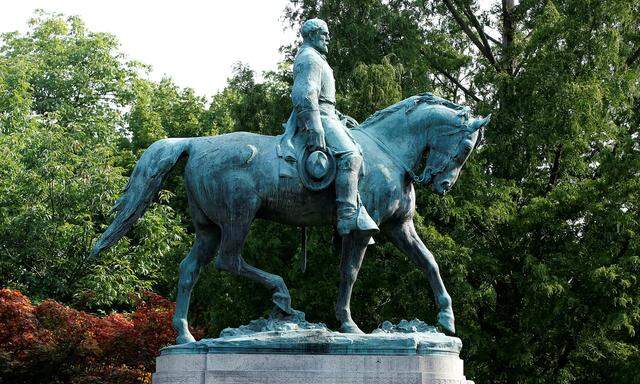 A sign on the statue of Robert E. Lee calls for the park to be renamed for Heather Heyer, who was killed at in a far-right rally, in Charlottesville, Virginia