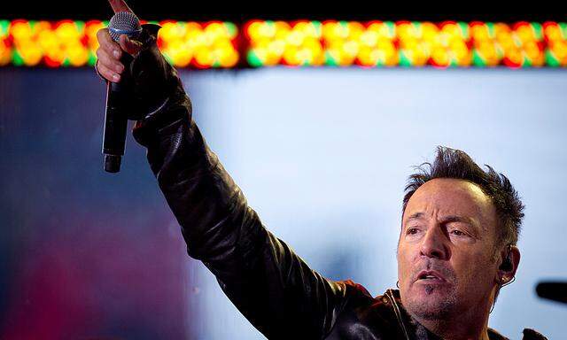 FILE PHOTO - Bruce Springsteen performs with U2 during a surprise concert in support of World AIDS Day in Times Square in New York