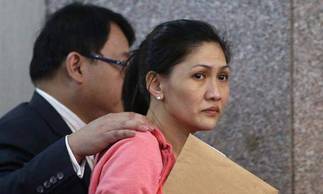 Maia Santos Deguito, a branch manager of the RCBC is escorted by her lawyer after testifying at a Philippine Senate in Manila
