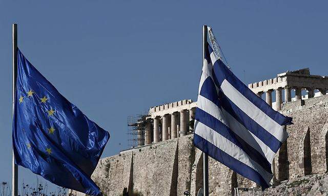 A Greek and an EU flag flutter in front of the temple of the Parthenon during the takeover ceremony of the six-month rotation of Greece's EU Presidency in Athens