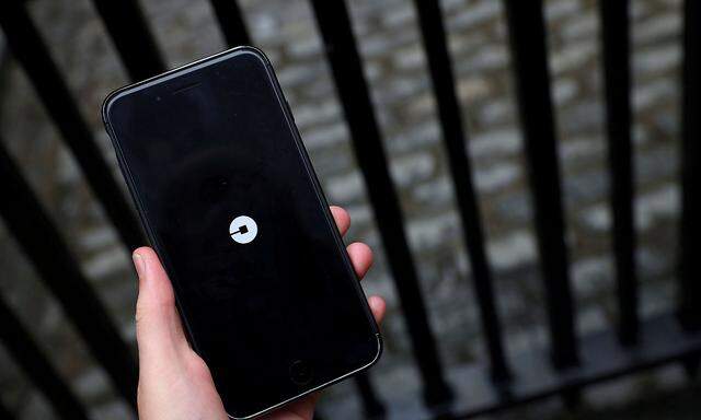 FILE PHOTO: The Uber logo is seen on mobile telephone in London