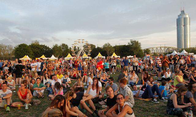 Visitors relax at Donauinselfest open air festival in Vienna