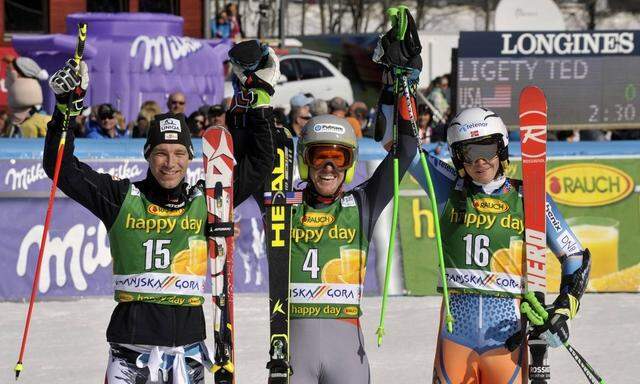 Winners celebrate in the finish area after the Alpine Skiing World Cup men's giant slalom ski race in Kranjska Gora
