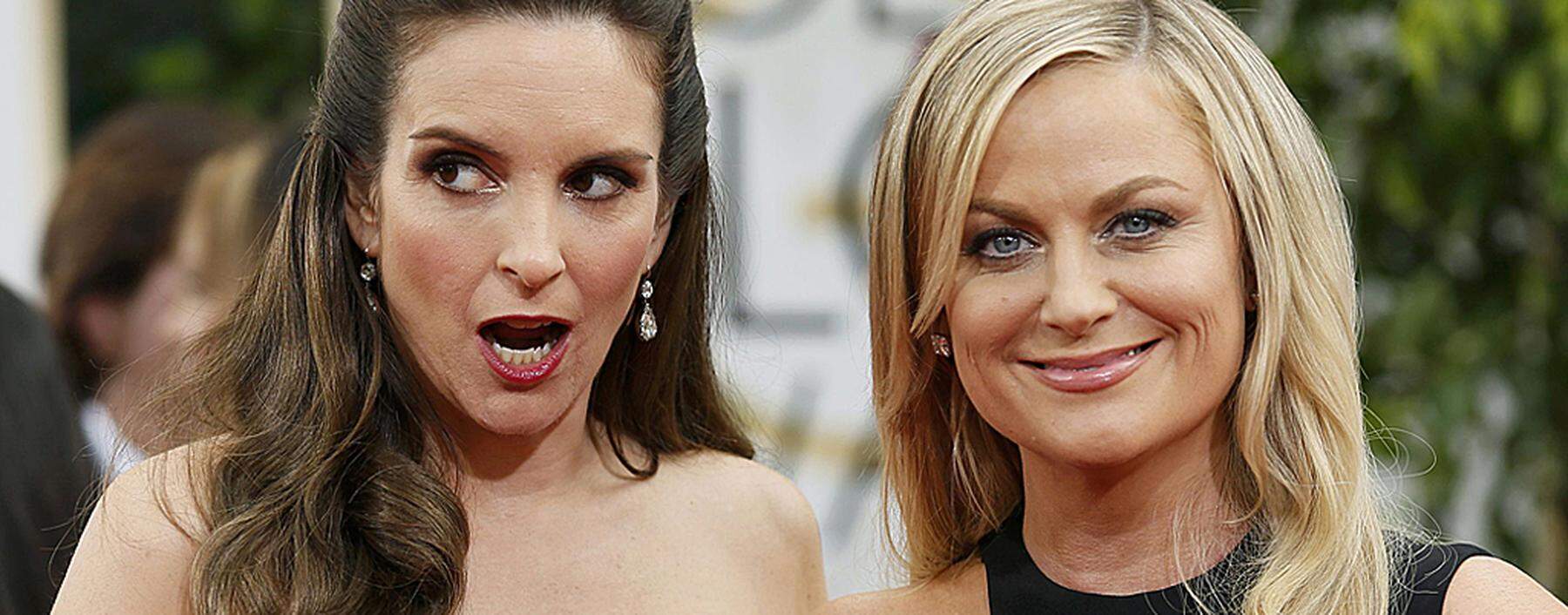 Golden Globes hosts Tina Fey and Amy Poehler pose at the 71st annual Golden Globe Awards in Beverly Hills