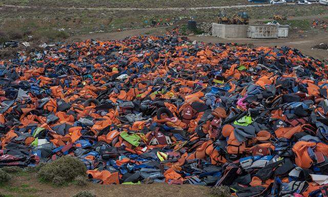February 27 2016 Lesbos Greece A pile of lifejackets left behind by refugees and migrants who