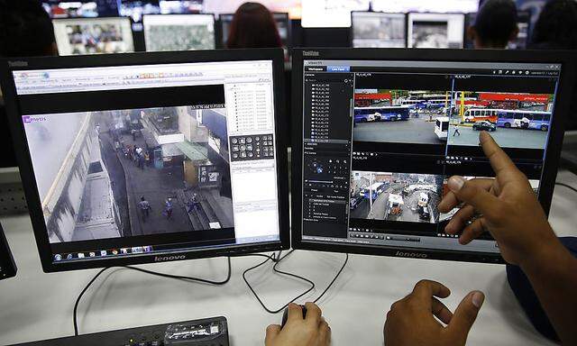 A Venezuelan official points at a monitor screen at the headquarters of SIMA in Caracas