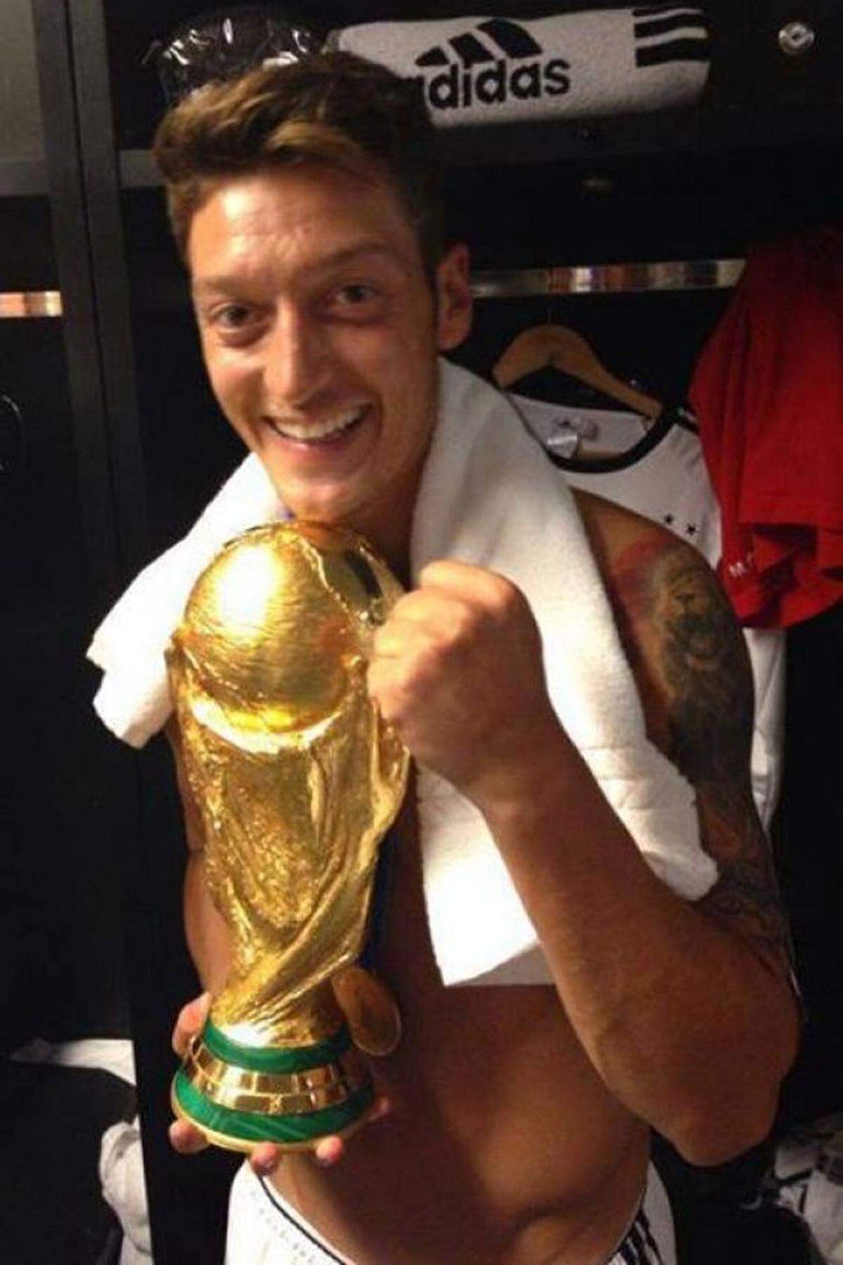 Eine verdiente Siegerfaust von Mesut Özil, der deutsche Spieler zeigt den Cup und schreibt auf Facebook: "don't ever let somebody tell you, you can't do something. believe in your dreams!"