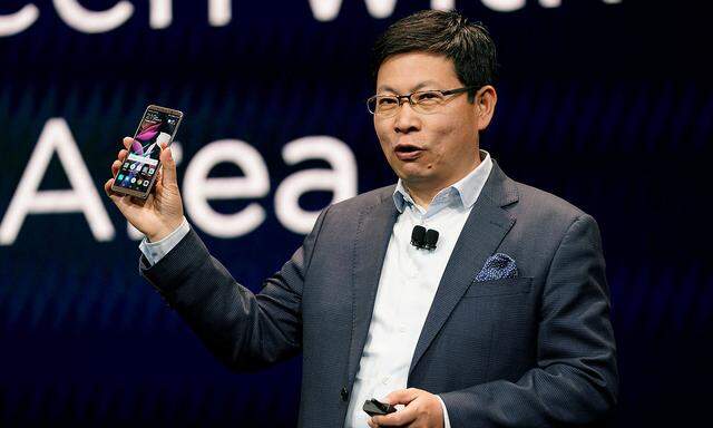 Richard Yu, CEO of the Huawei Consumer Business Group, holding a Huawei Mte 10 Pro cellphone, speaks at the Huawei keynote at CES in Las Vegas