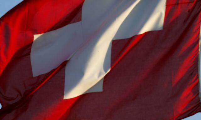 A Switzerland national flag flies in front of a building of Swiss drugmaker Novartis in Zurich