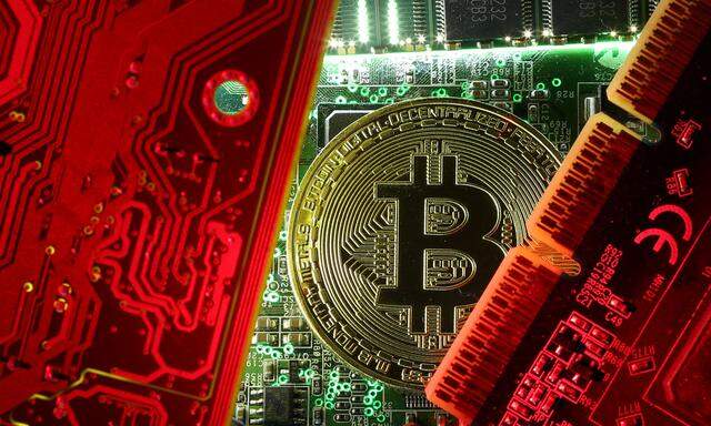 FILE PHOTO: Copy of bitcoin standing on PC motherboard is seen in this illustration picture