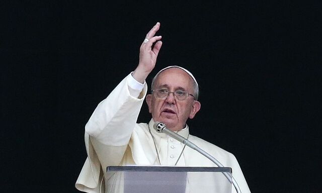 Pope Francis blesses the faithful during his Angelus prayer in Saint Peter's Square at the Vatican