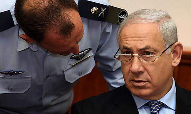 Israeli Prime Minister Benjamin Netanyahu, right, speaks with his military secretary Major General Yo