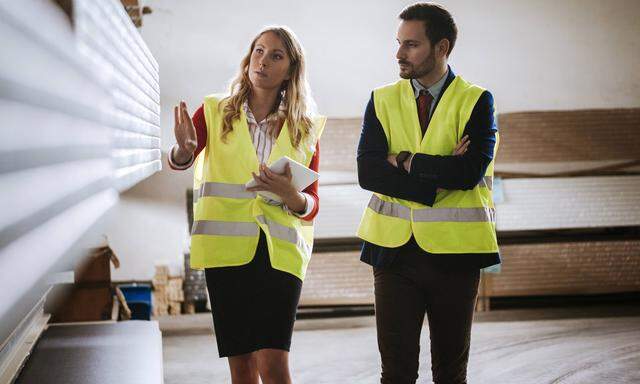 Man and woman in warehouse supervising stock model released Symbolfoto property released PUBLICATION
