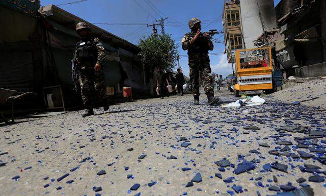 Afghan security forces keep guard at the side of an attack after gunmen attack in Jalalabad city