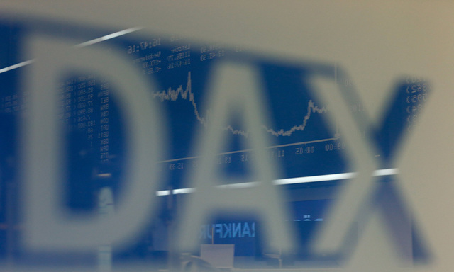 The German share price index DAX board is reflected in a glass at the stock exchange in Frankfurt