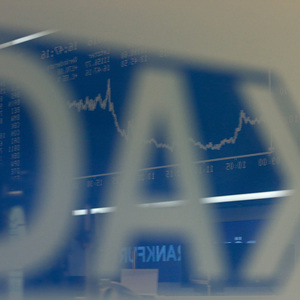 The German share price index DAX board is reflected in a glass at the stock exchange in Frankfurt