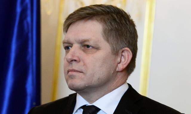 Slovakia's Prime Minister Robert Fico reacts after a meeting of SlovakiaâAeOes three top officials at the Bratislava castle