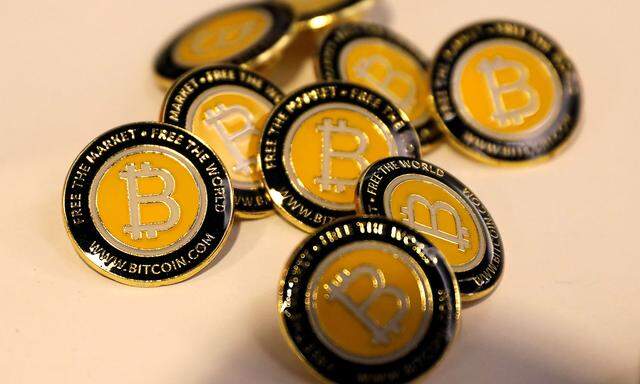 FILE PHOTO: Bitcoin.com buttons are seen displayed on the floor of the Consensus 2018 blockchain technology conference in New York City