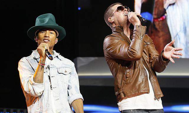 Singer Pharrell Williams and singer Robin Thicke perform together at the Walmart annual shareholders meeting in Fayetteville