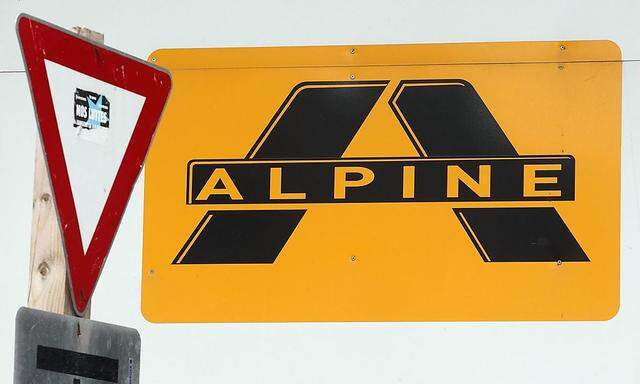 A logo of Alpine Bau is pictured next to a traffic sign at a construction site in Vienna