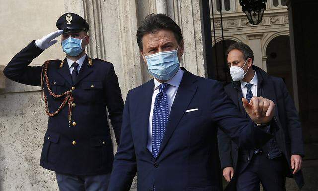 The outgoing Italian premier Giuseppe Conte gets out of Palazzo Chigi and waves to the press just before holding his la