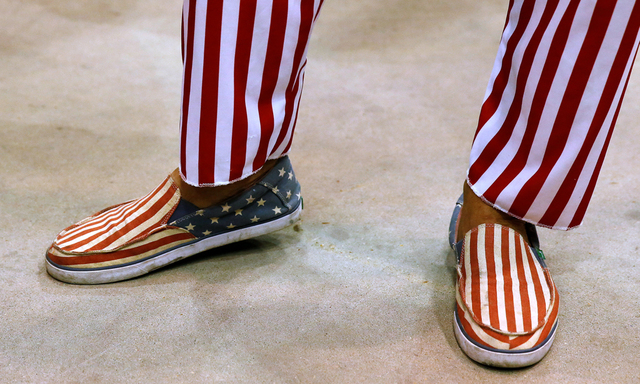The U.S. flag themed shoes and pants of a man dressed up as Uncle Sam are pictured as he waits for Republican presidential nominee Donald Trump at a campaign rally in Jackson