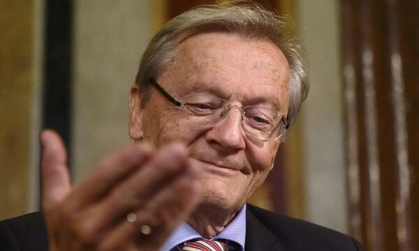 Former Austrian Chancellor Schuessel gestures as he waits to testify in a parliamentary inquiry hearing investigating political responsibilities leading to the fail of Hypo Alpe Adria bank in Vienna