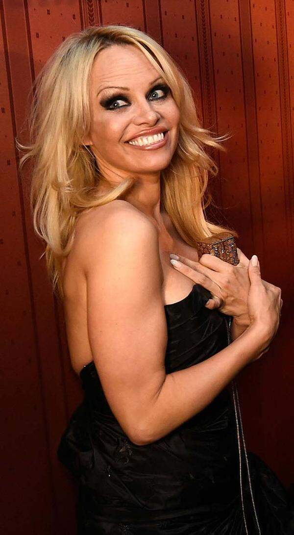 Pamela Anderson sprang in einem schwarzen trägerlosen Kleid für Alain Delon ein.