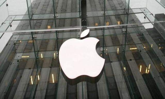 The Apple logo hangs at the entrance to the Apple store on Fifth Avenue in New York