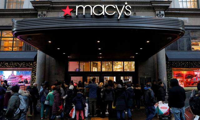 FILE PHOTO: People gather at Macy's Herald Square store ahead of early opening for the Black Friday sales in Manhattan