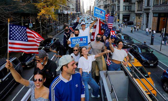 A group of friends who live in New York City celebrate after former Vice President Joe Biden was declared the winner of the 2020 U.S. presidential election