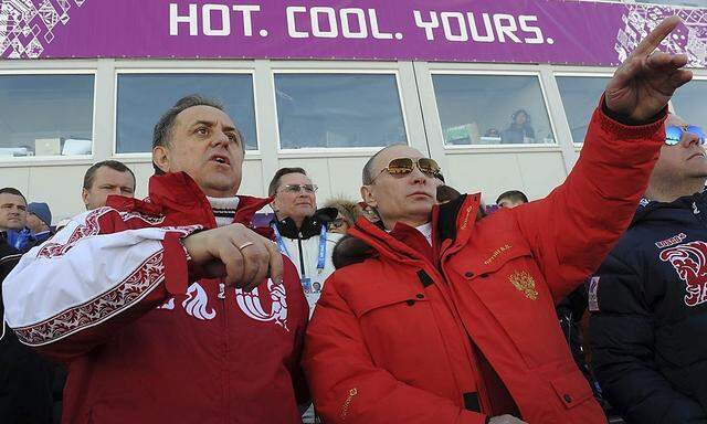 Russian President Putin and Sports Minister Mutko watch the cross country skiing men's relay during the Sochi 2014 Olympic Winter Games at Laura Cross-Country Ski and Biathlon Center near Krasnaya Polyana