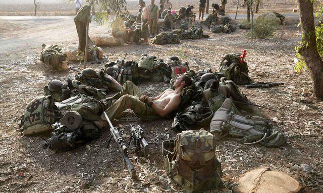 An Israeli soldier from the Nahal Brigade rests after returning to Israel from Gaza