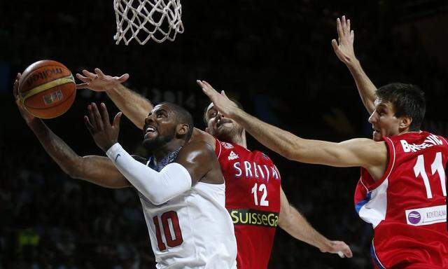 Irving of the U.S. goes up for a basket past Serbia's Krstic and Bircevic during their Basketball World Cup final game in Madrid