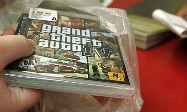 ** FILE ** In this April 29, 2008 file photo, a clerk bags a copy of Grand Theft Auto IV at a Circuit