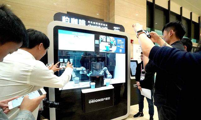 181104 SHANGHAI Nov 4 2018 Journalists take photos of a cafe served by robotic arms at t