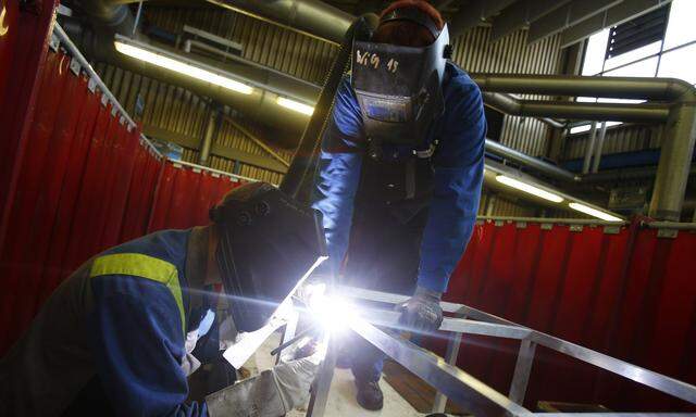 A trainee uses welding equipment during a daily trainee program at the Voest Alpine factory in the Austrian city of Linz