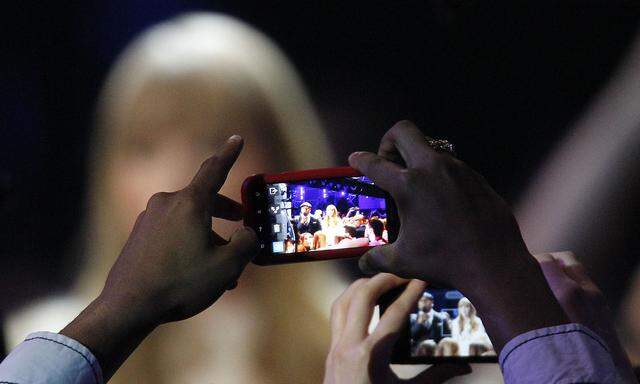 Fans take photos of Taylor Swift and LL Cool J with their cell phones as they host the Grammy Nominations Concert in Nashville